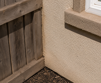 Wood fence connects directly to south wall